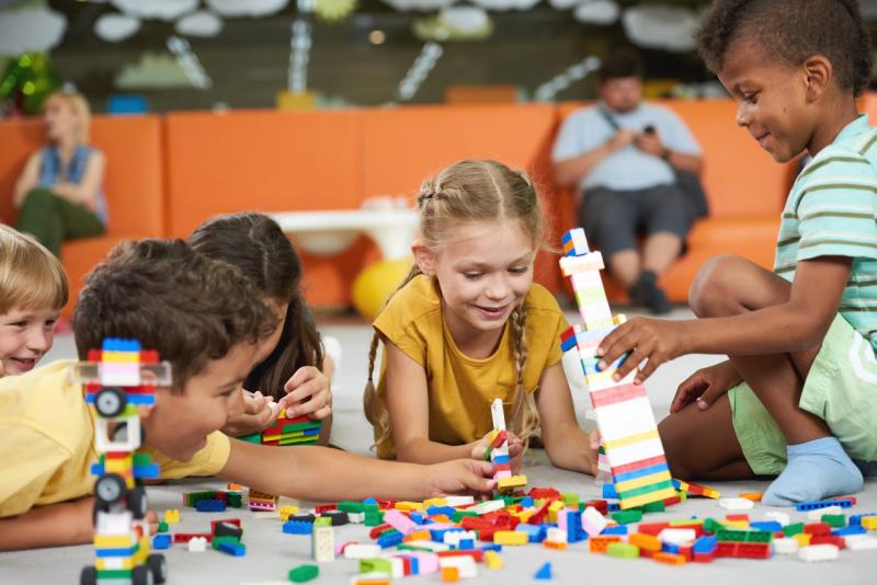 a group of children building blocking together